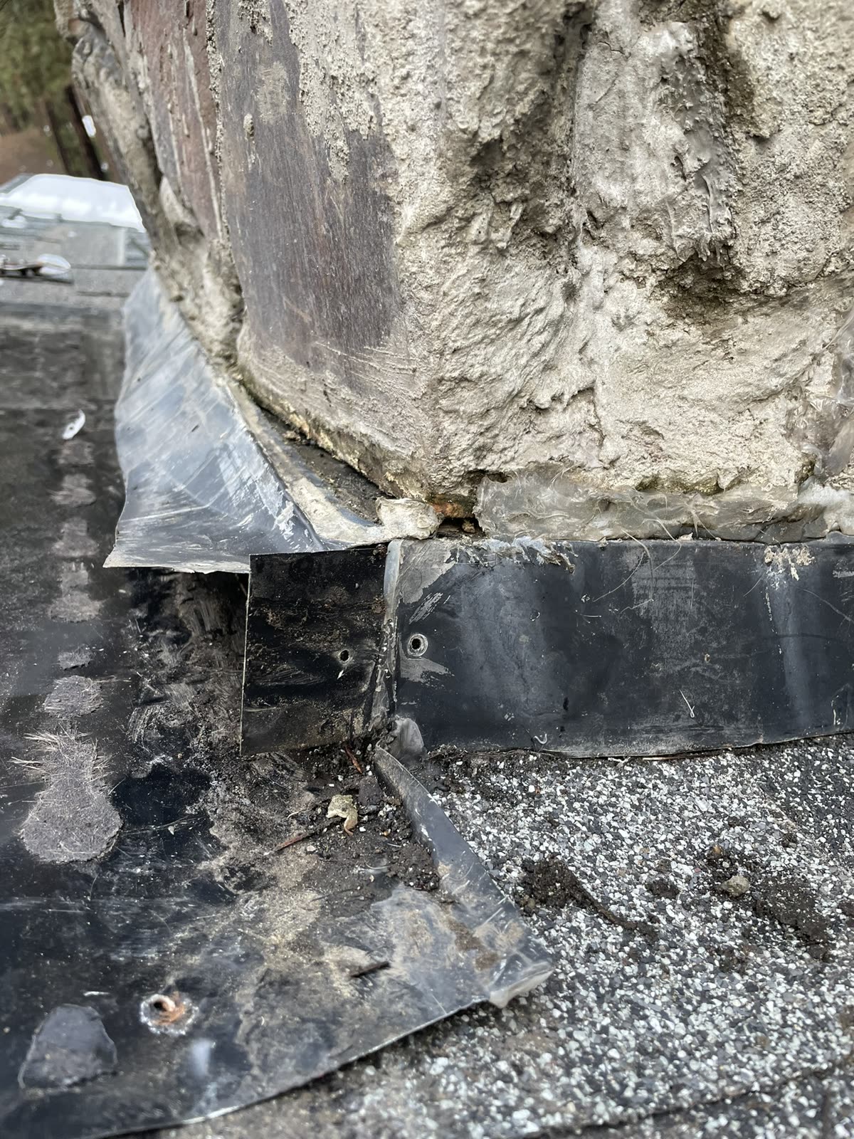 Existing chimney flashing opened for inspection before repair