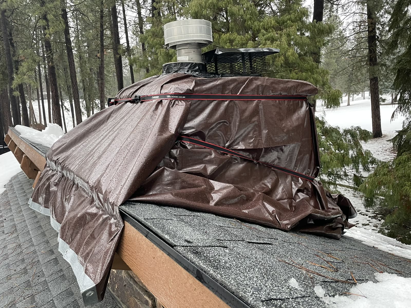 Roof and chimney repair area protected from winter weather