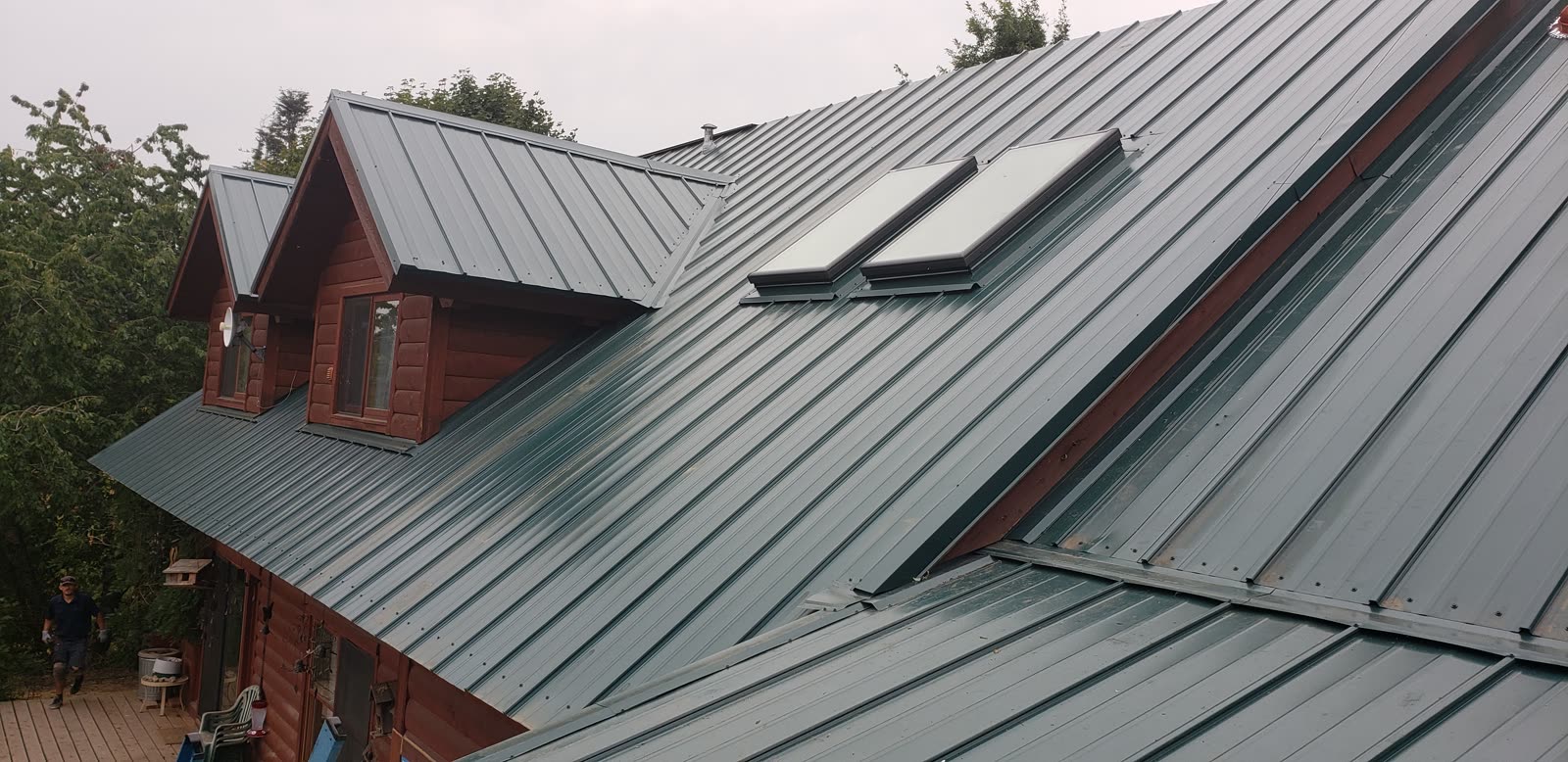 Finished residential metal roof with dormers and skylights