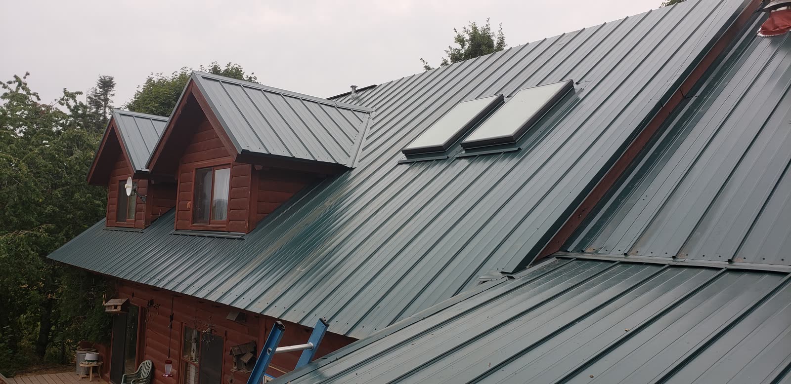Completed metal roof replacement across a complex residential roof